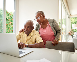 A couple looking at planned giving options on their computer. Links to Beneficiary Designations A couple looking at planned giving options on their computer. Links to Beneficiary Designations