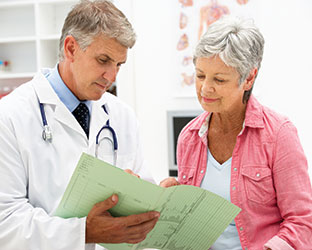 Photo of a doctor going over papers with a patient. Link to What to Give. Photo of a doctor going over papers with a patient. Link to What to Give.